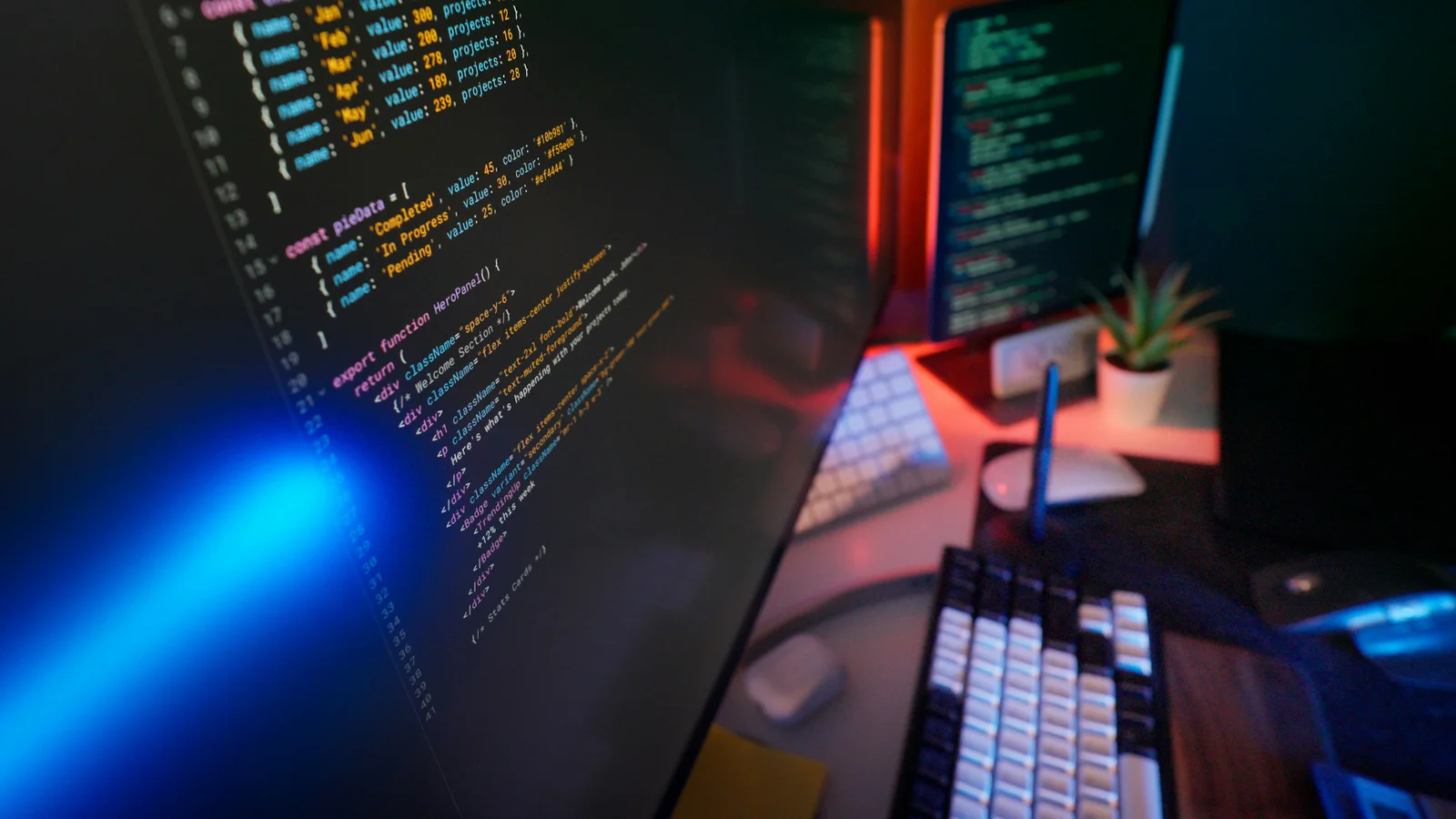 Real workstation with programming code visible across multiple screens