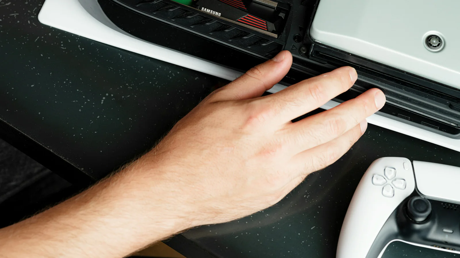 Official Samsung Memory photograph of a person installing storage inside a game console